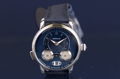 a close up of a watch on a black surface