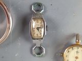 three different types of watches sitting on a table