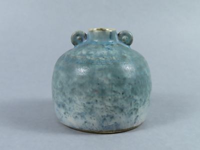 a blue vase with two handles on a white surface