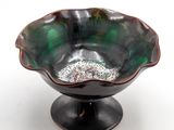 a black bowl with a green and white design on it