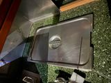 a stainless steel tray with a lid on a counter