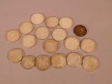 a small amount of coins on a table next to a penny