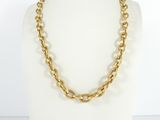 a close up of a gold chain necklace on a mannequin
