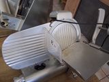 an image of a meat slicer sitting on the floor