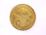 a close up of a gold coin on a white surface