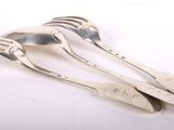 three silverware spoons and a fork on a white surface