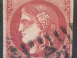 un timbre rouge sur lequel figure le visage d'une femme