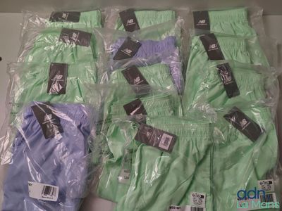 several pairs of men ' s green and blue boxers are wrapped in plastic