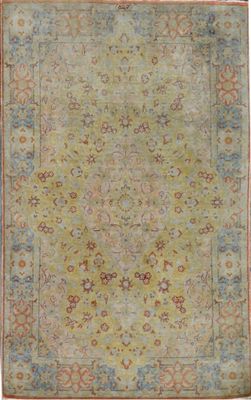 an antique rug with a green field and red border