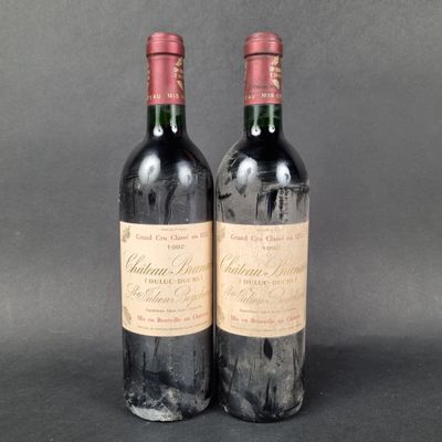 two bottles of wine sitting next to each other on a table