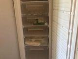an image of a refrigerator in a kitchen with the door open