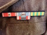 a close up of a jacket with a ribbon on it
