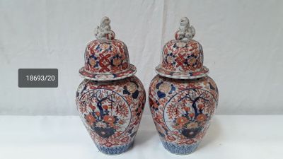 two vases that are sitting on a table