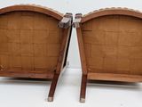 pair of mid - century style chairs with woven seats on wooden legs