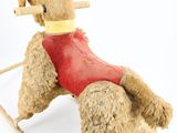 a teddy bear that is sitting on a rocking chair