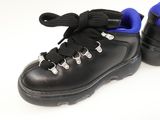 a pair of black shoes with blue soles on a white surface