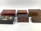 four wooden boxes are lined up on a white surface