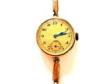 une montre-bracelet en or avec une trotteuse bleue
