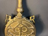 pair of antique brass perfume bottles with floral designs on them