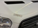 a close up of the front of a white truck with a sticker on it ' s hood