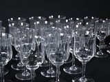 many empty wine glasses lined up on a black table