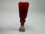 an image of a red glass vase with a silver base