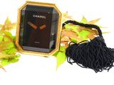 a black and gold clock with a tassel around it