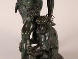 bronze statue of a man and a dog on a marble base