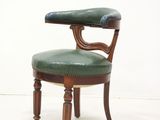 leather upholstered chair with wooden legs and armrests