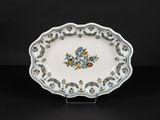 a white plate with blue and yellow flowers on it