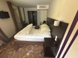 a picture of a hotel room with a bed and a tv