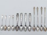 several spoons and spoon spoons are lined up on a white surface