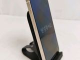 a cell phone that is on a stand on a table