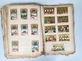 an open book with pictures of people and animals on it