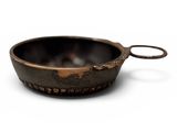 a close up of a metal bowl on a white surface