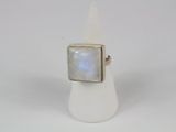 a close up of a ring with a white stone in it