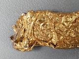 a close up of a piece of gold on a table