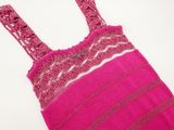 pink crocheted dress with pink and brown stripes on a white background