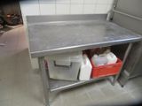 a stainless steel work table with two buckets of water on it