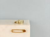a gold pin sitting on top of a marble block
