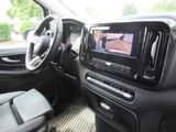 the interior of a car with a flat screen tv and a steering wheel