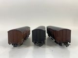 three toy train cars sitting side by side on a white surface