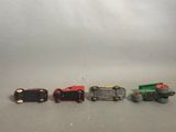 four toy trains that are lined up in a row