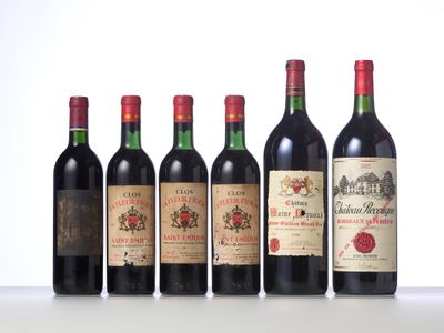 six bottles of wine are lined up on a table