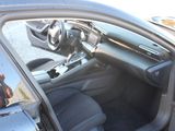 the interior of a car with the door open and the driver ' s seat down