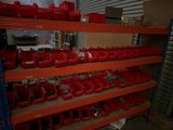 many red bins on the shelves in the warehouse