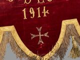 a large red and gold banner with a cross on it