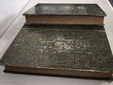 two old books sitting on a white table
