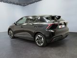 the rear end of a black car in a showroom