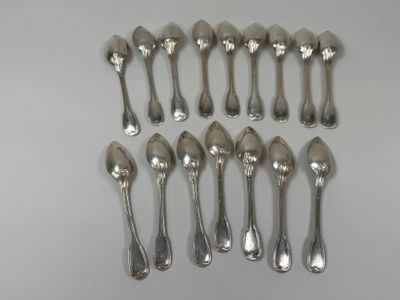 six silver spoons are arranged in a row on a white surface